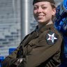 Katherine Profitt standing with arms crossed in Army uniform.