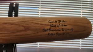 A baseball bat with the inscription "Garrett Shelton Police Chief Old Dominion University."