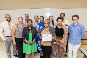 Ebony Clark poses for a photo with her coworkers and members of ODU's Division of Talent Management and Culture.