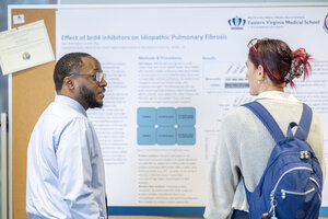 Students chatting at a research expo
