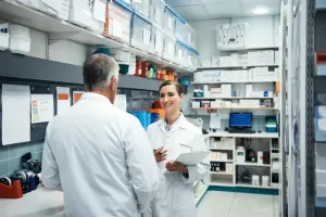 2 medical professionals conversing in a lab