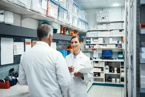 2 medical professionals conversing in a lab