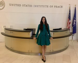 Helen Crompton, Ph.D., stands in the lobby at the United States Institute of Peace