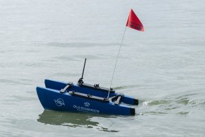 Small unmanned remote-controlled boat in water
