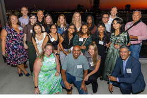 Group of alumni smile in a group shot
