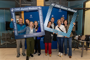 Group of alumni holding photo frames