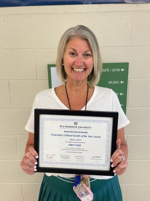 Ms. Amy Gray poses for a photo with her certificate for the 2024-25 Clinical Faculty of the Year Award.