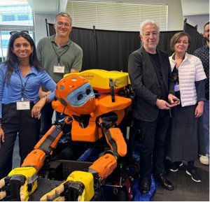 anca dobrian with other faculty and a robot