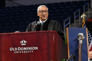 Photo of a man speaking at a podium.