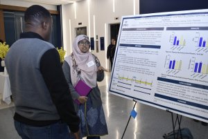 Two people discussing research at Research Day.