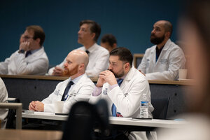 doctors in white coats attend a lecture