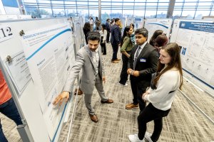 student presenting a poster at research day