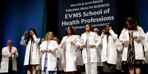 Students receiving white coats