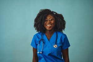 woman doctor smiling with stethoscope looking front