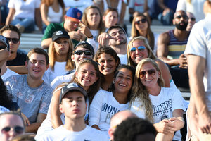 Students pose at a football game.
