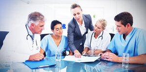 Team of doctors and businesswoman having a meeting