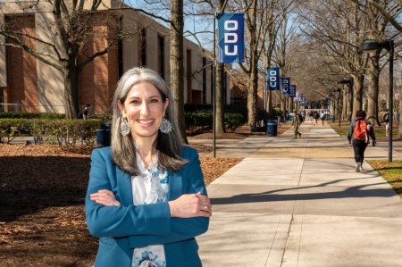 Krista Harrell stands in front of Kaufman Hall on the ODU campus.