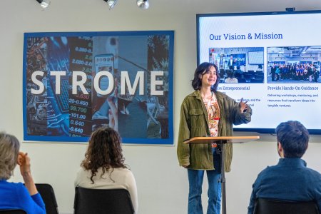 Female student gives group presentation.
