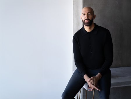 ODU alumnus Damien Geter sits on the corner of a table