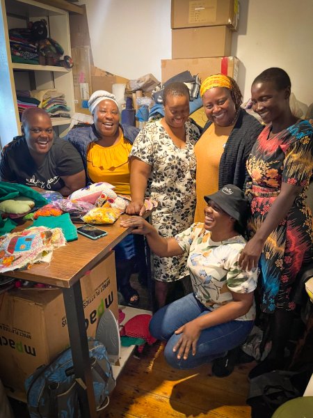 Solani Ndlovu, Yolanda Chari, Andisiwe Somagaca, Melissa Miller-Felton, Florence Munguni and Ntsapokazi Somagaca sit in a room. 