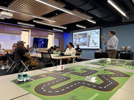 Tabletop obstacle course and people at a presentation