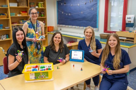 Women at table with LEGOs