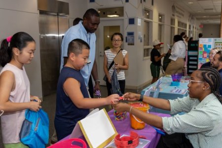 Nursing students interact with kids at indoor community event