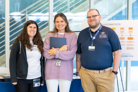 Three Community-Engaged Learning staffers smile at the camera