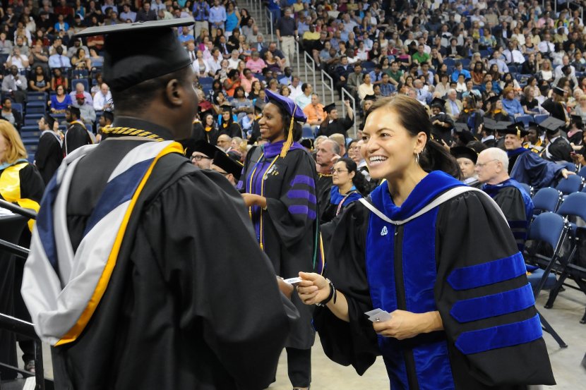 A graduate receives his welcome gift from the alumni associa