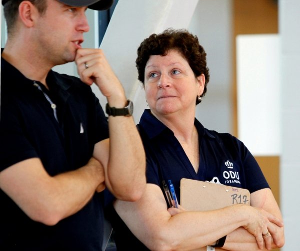 Photo of Betsy Kennedy talking with a participant's parent.