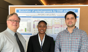 Musto with two researchers in front of a poster presentation