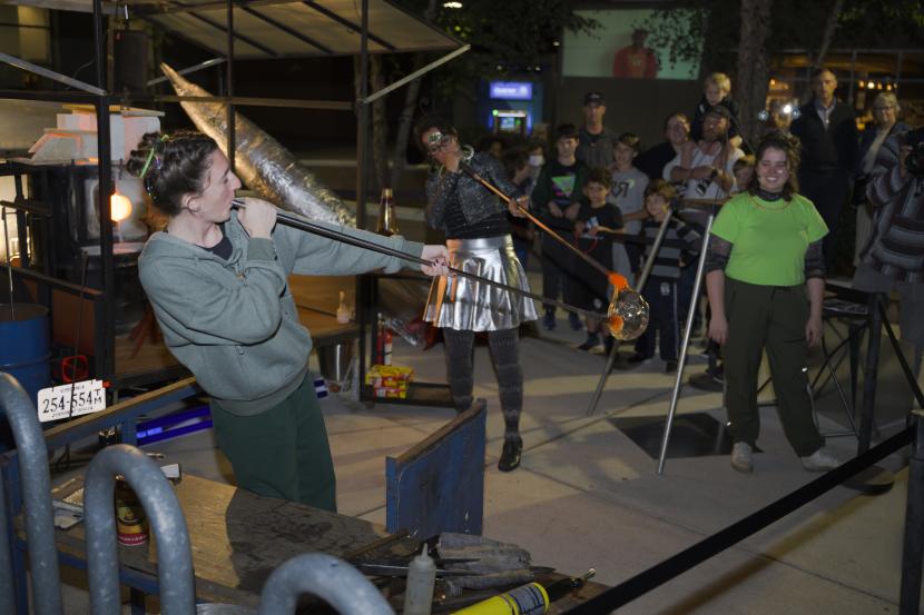 Members from the Chrysler Museum demonstrate glassblowing te