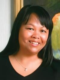 Agatha Parks-Savage has long dark hair, is wearing a black s