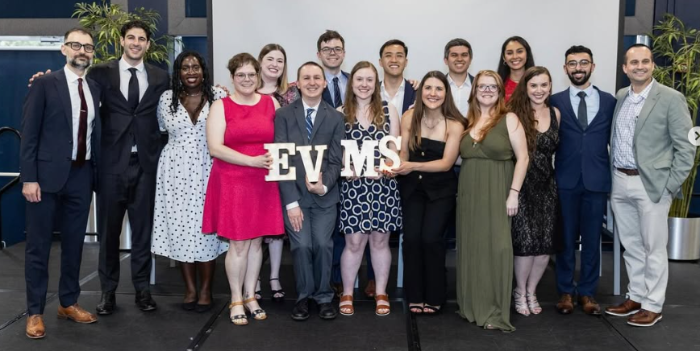 Group holding an EVMS banner