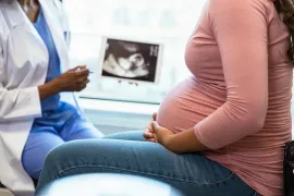 Pregnant woman seeing ultrasound with OBGYN.