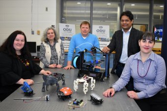 Photo of Anthony Dean, Ph.D., (center), assistant dean for r