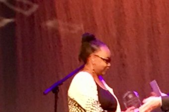 Melvina Sumter receiving an award from Dean Sandstrom