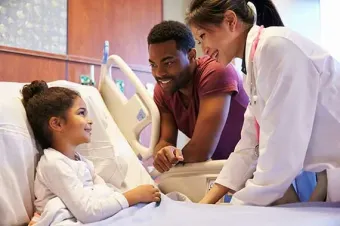 A doctor consults with a pediatric patient.