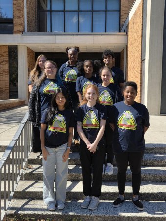Biological Sciences Support Facility group photo of 9 people standing arranged on the staircase.
