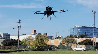 Drone in the air with Waitzer Hall in the background.