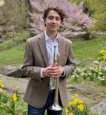 Taylor Hubbard holding his trumpet.
