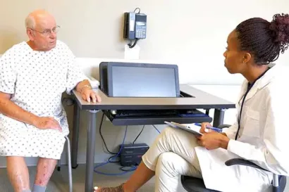 A resident talks with a Standardized Patient during a simula